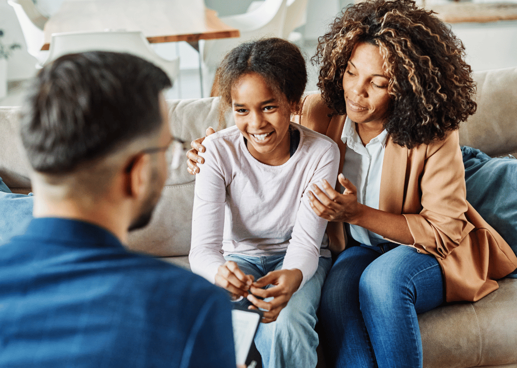 Young girl and caregiver with counselor
